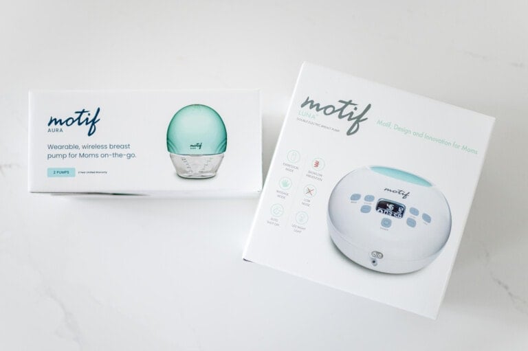 The image shows two Motif brand product boxes on a white surface. One box is for the Motif Aura, a wearable, wireless breast pump, while the other is for the Motif Luna, a double electric breast pump with a battery.