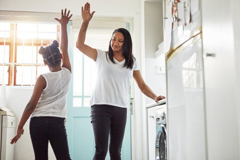Shot of a mother and daughter high-fiving after finishing their chores