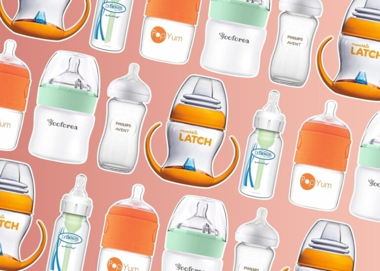 A variety of the best baby bottles from different brands, including Dr. Brown's, Philips Avent, PopYum, and Munchkin Latch, are arranged on a pink background. The bottles vary in design, with some having handles, different nipple shapes, and color accents, primarily orange.