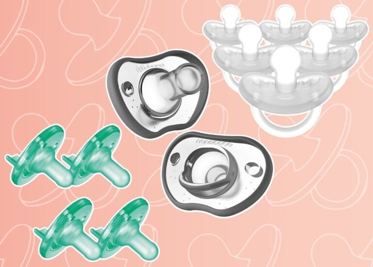 The image displays several baby pacifiers against a peach-colored background. The pacifiers are of varying designs and colors, including clear, green, and white. Some are depicted in a duo arrangement, and others are shown in groups of four or five - showcasing some of the best pacifiers for breastfed babies.