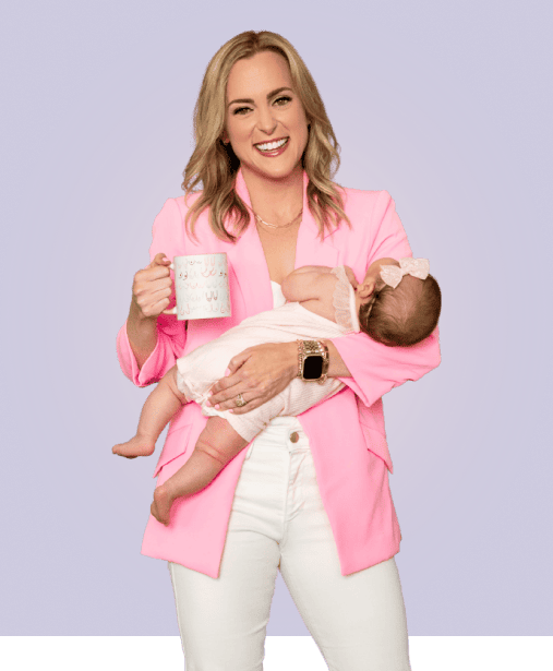 A woman with blonde hair, wearing a pink blazer and white pants, is holding a baby in one arm and a coffee mug in the other. The baby is dressed in a light pink outfit and has a bow on its head. The background is a solid light purple color.
